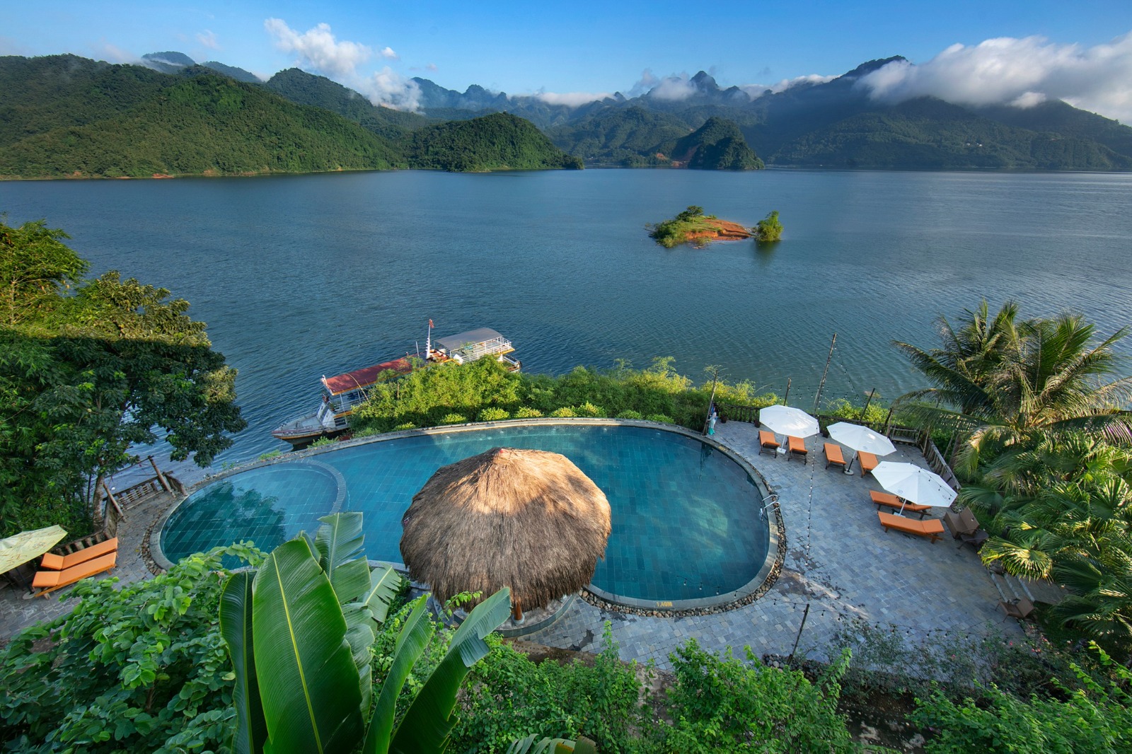 Infinity pool resort overlooking lake and mountains
